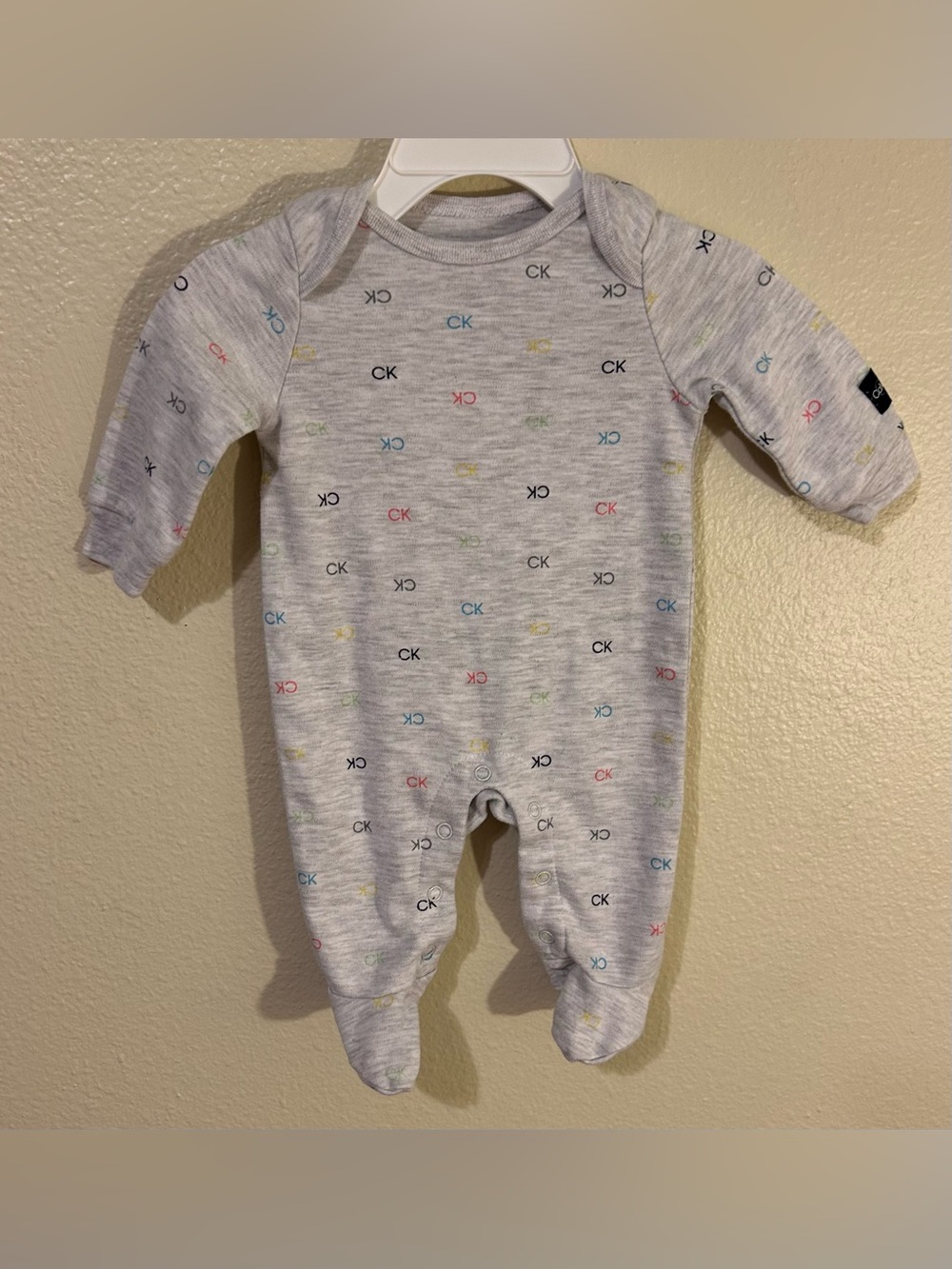 Calvin Klein Sleeper Gray with Multi Color CK Logo Pattern EUC 0-3 Months